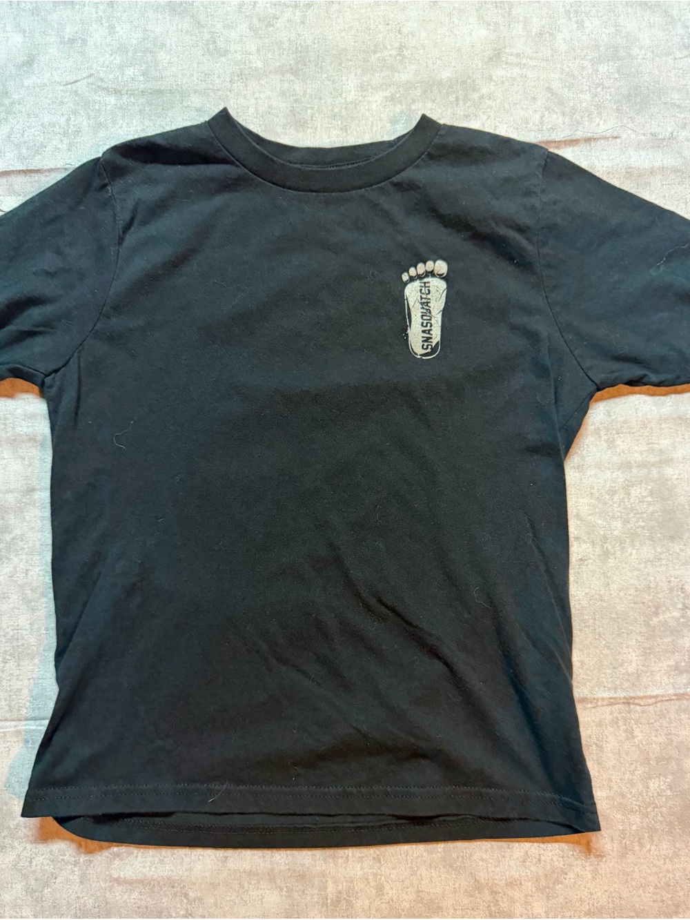 Next Level Apparel Black Tee with Small Footprint Graphic